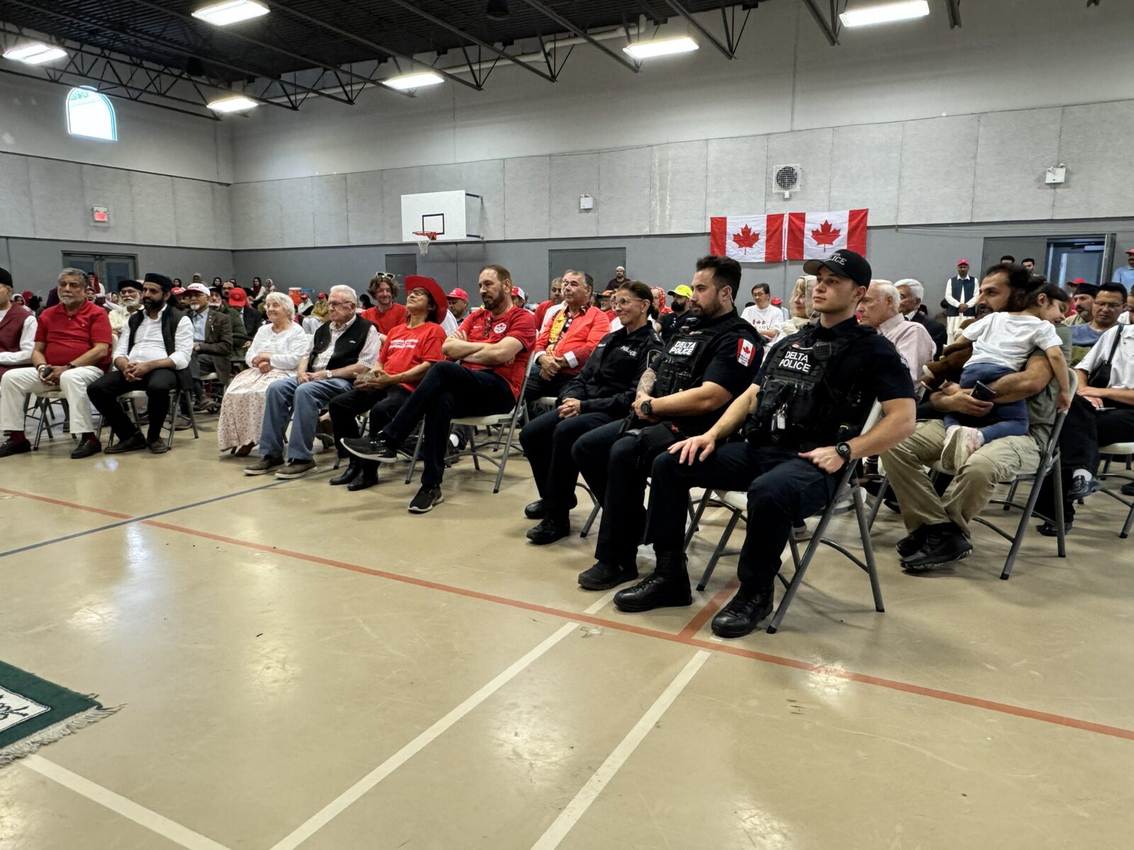 Guests and local police officers seated together at a community event